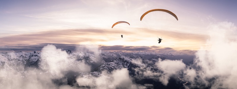 paragliders flying high in the mountains